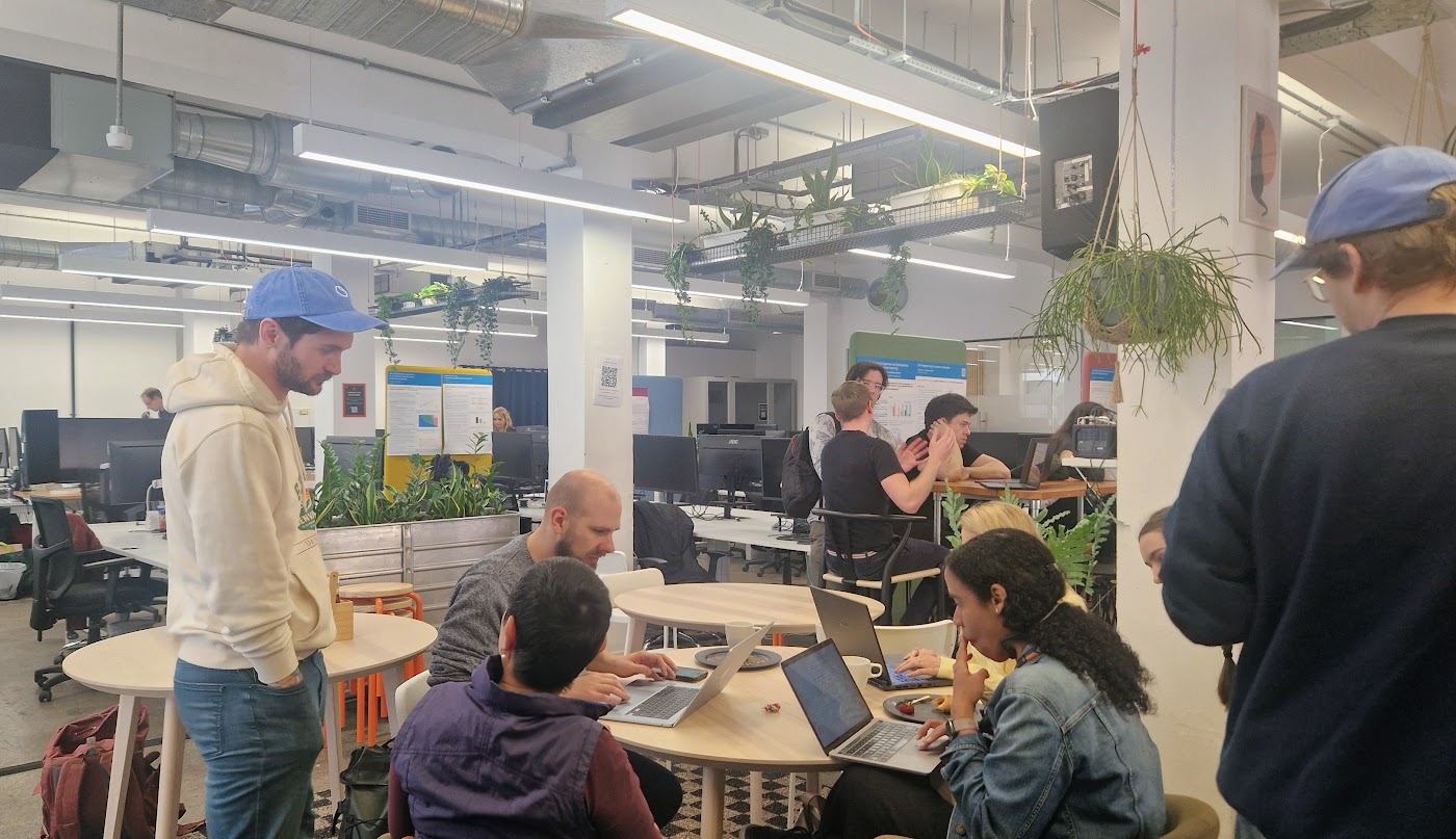 Builders at the tables, mid-hack